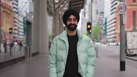 Young-Indian-Punjabi-Sikh-Man-Looks-To-The-Camera-Then-Smile