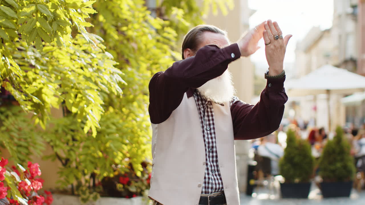Cheerful rich old man showing wasting throwing money win lottery share celebrate in city street