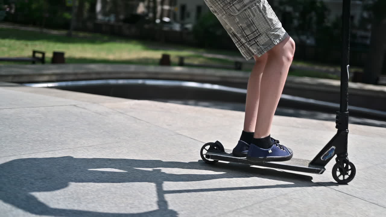 Boy jumping on a skateboard in a sport park, slow motion