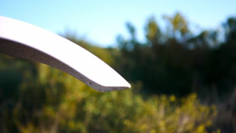 Close-up-of-the-front-wheel-and-tread-of-an-off-road-dirt-bike-then-rack-focus-to-the-surrounding-landscape