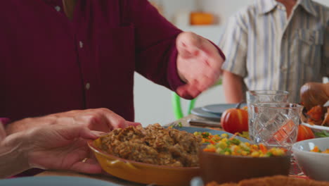 Multi-Generation-Family-Celebrating-Thanksgiving-At-Home-Eating-Meal-Together