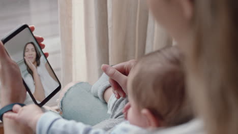 young mother and baby having video chat with best friend using smartphone waving at toddler happy mom enjoying sharing motherhood lifestyle