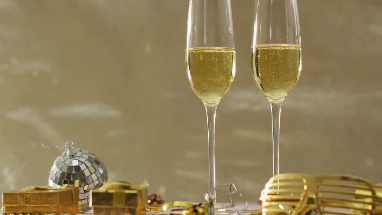Champagne glasses and decorations on green background at new year's eve