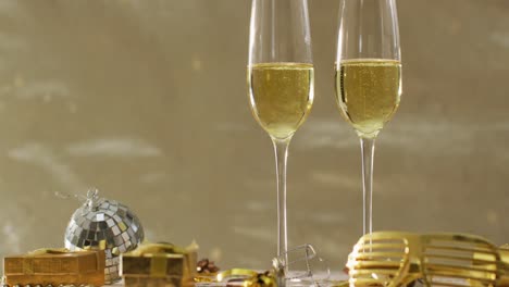 champagne glasses and decorations on green background at new year's eve