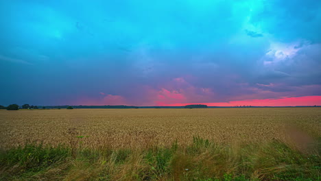 timelapse of rain showers moving over a field while sky colors by sunset