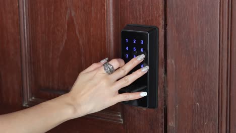 person entering code on a digital keypad lock