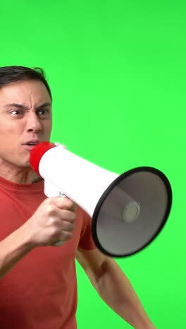 man shouting into a megaphone on green screen