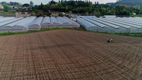 Aerial-view-of-organized-complex-of-greenhouses-and-rural-fields