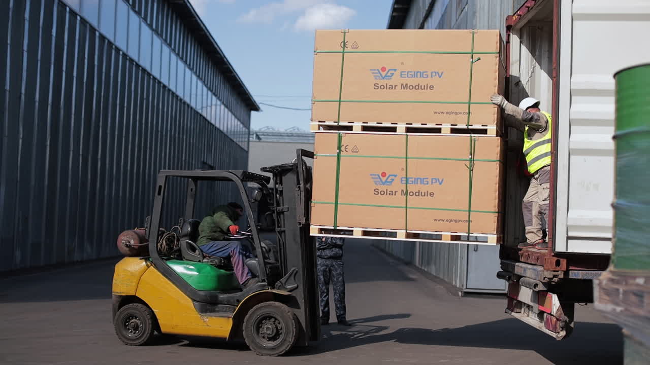 Forklift Loading Solar Panels onto Truck