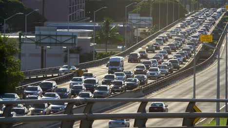 daily morning westbound traffic lines up on the h1 freeway in honolulu hawaii