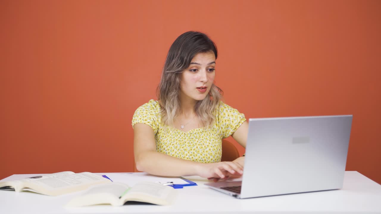 mujer joven mirando la computadora portátil con asombro.
