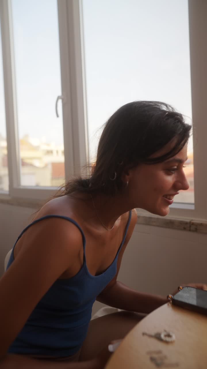 Young Woman Using a Spray Bottle Indoors by a Window