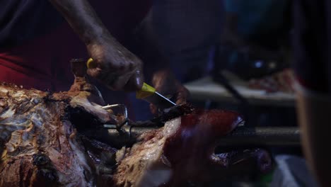 street food. pork being cooked over hot charcoal fire
