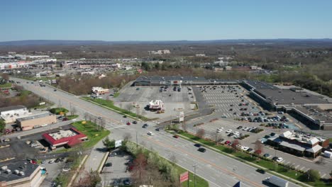 4k aerial drone footage of industrial shopping centers and strip malls in middletown new york and traffics can be seen with mountains in the background