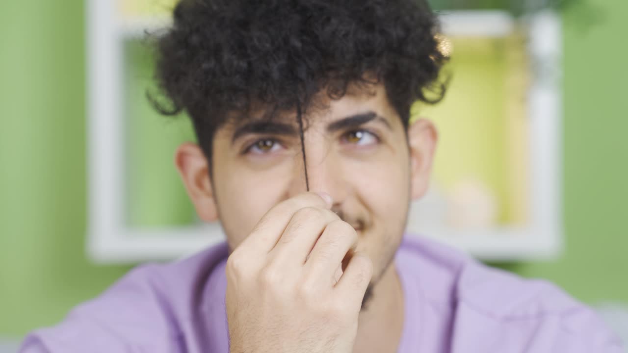 foto de cerca de la cara de un joven con el cabello rizado, linda y postura positiva.