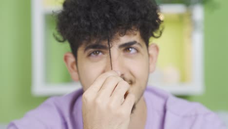 close-up face shot of young man with curly hair, cute and positive posture.