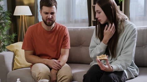 pareja sentada en el sofá en casa