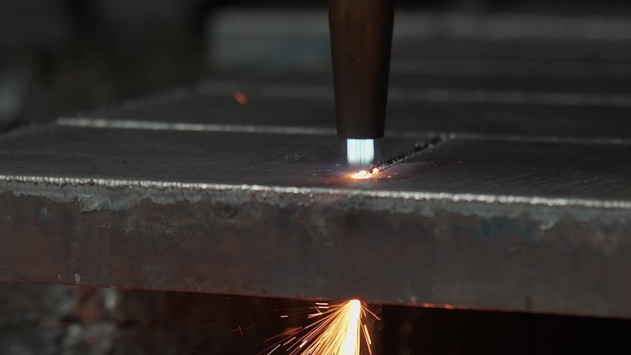 Plasma cutter close up - Cutting metal with high energy through heat and electrical power - Special tools in the metal industry - high resolution 4K shot in slow motion - Close up