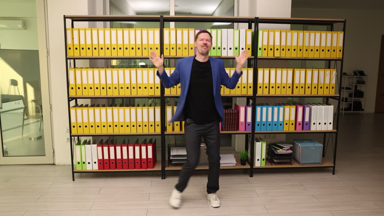 Man doing jumping jacks in an office