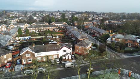 Aerial-view-frosty-white-winter-residential-town-neighbourhood-rooftops-panning-right