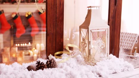 pine cone and lantern decoration on fake snow