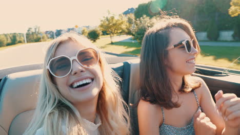 two happy women on a road trip in a convertible