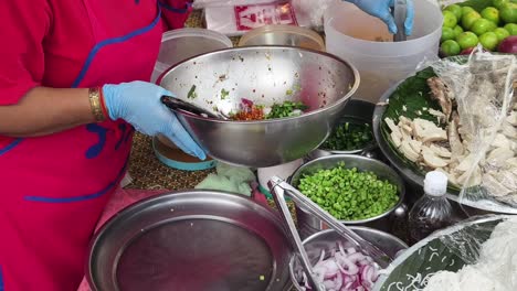 preparing som tum (thai papaya salad) at a market