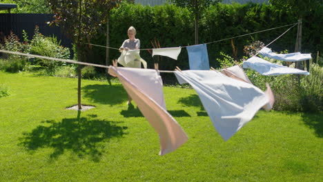 woman hanging laundry in a garden