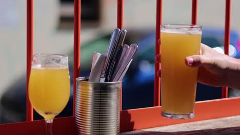 hand reaching for a glass of beer