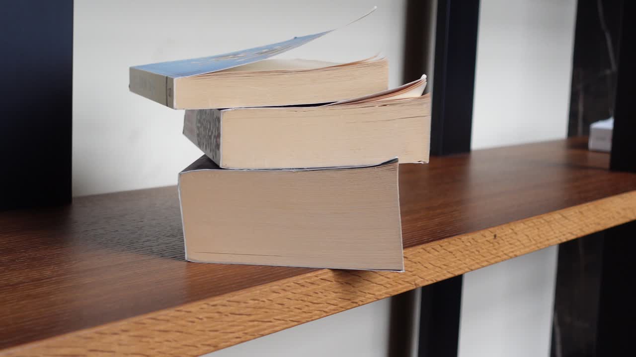 Stack of books on wooden table