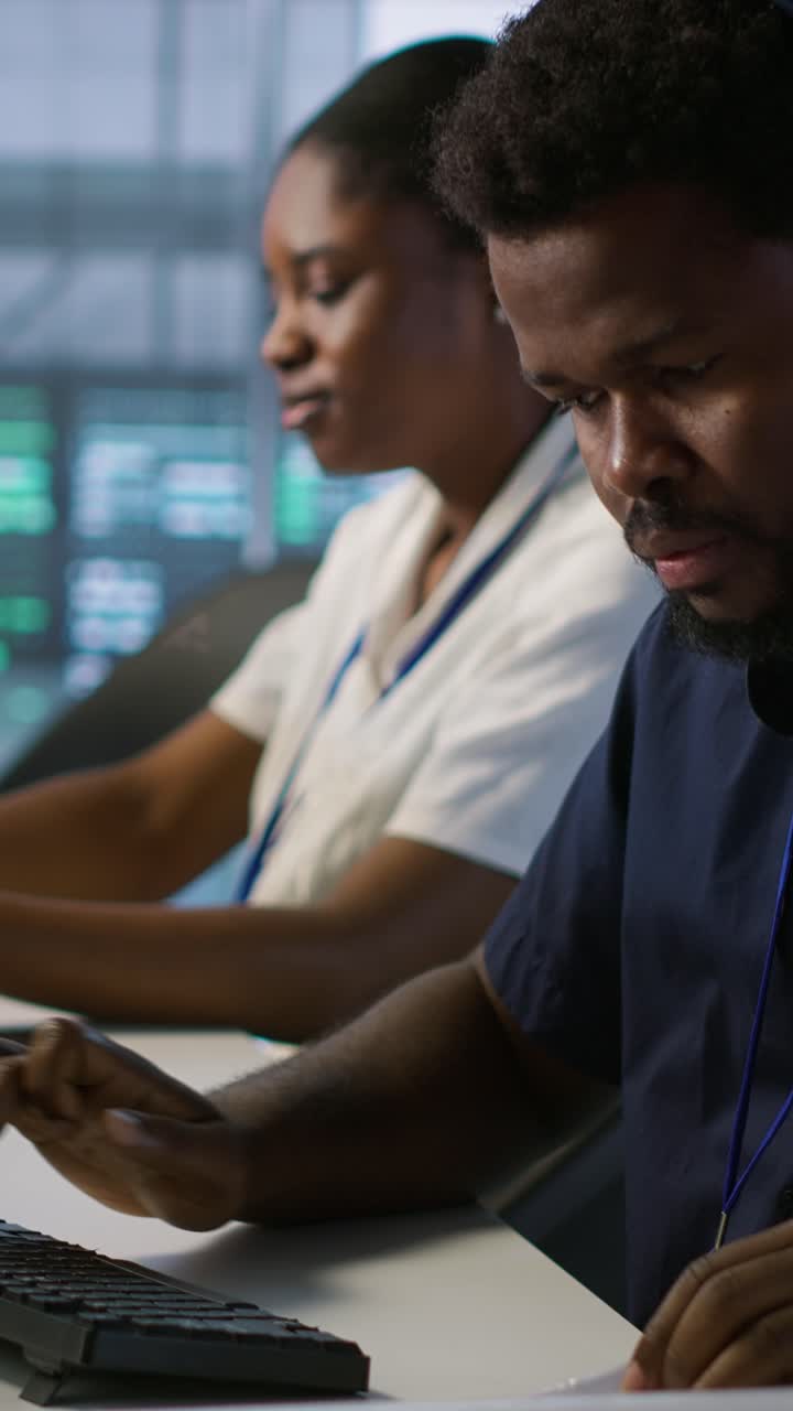 Vertical video Worker reading paperwork in data center, using analytics