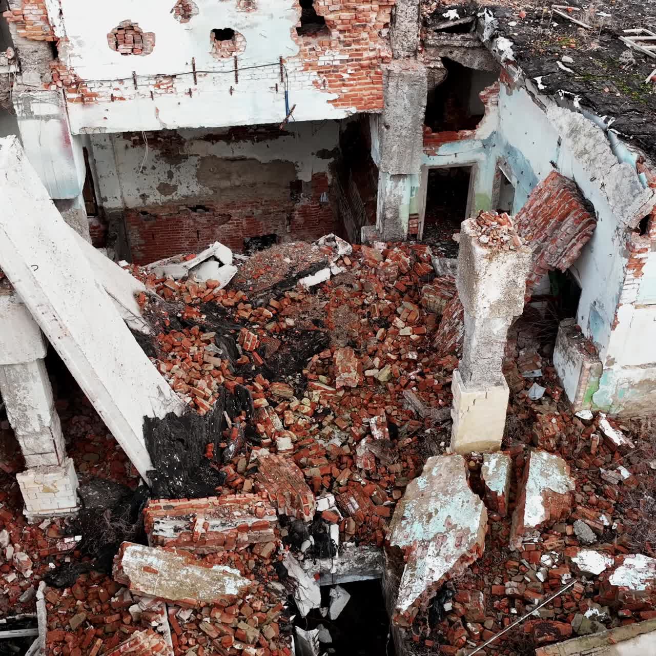 Ruins and wrecks of a destroyed urban territory. Demolished area with buildings into rubble after a natural disaster. Aerial view