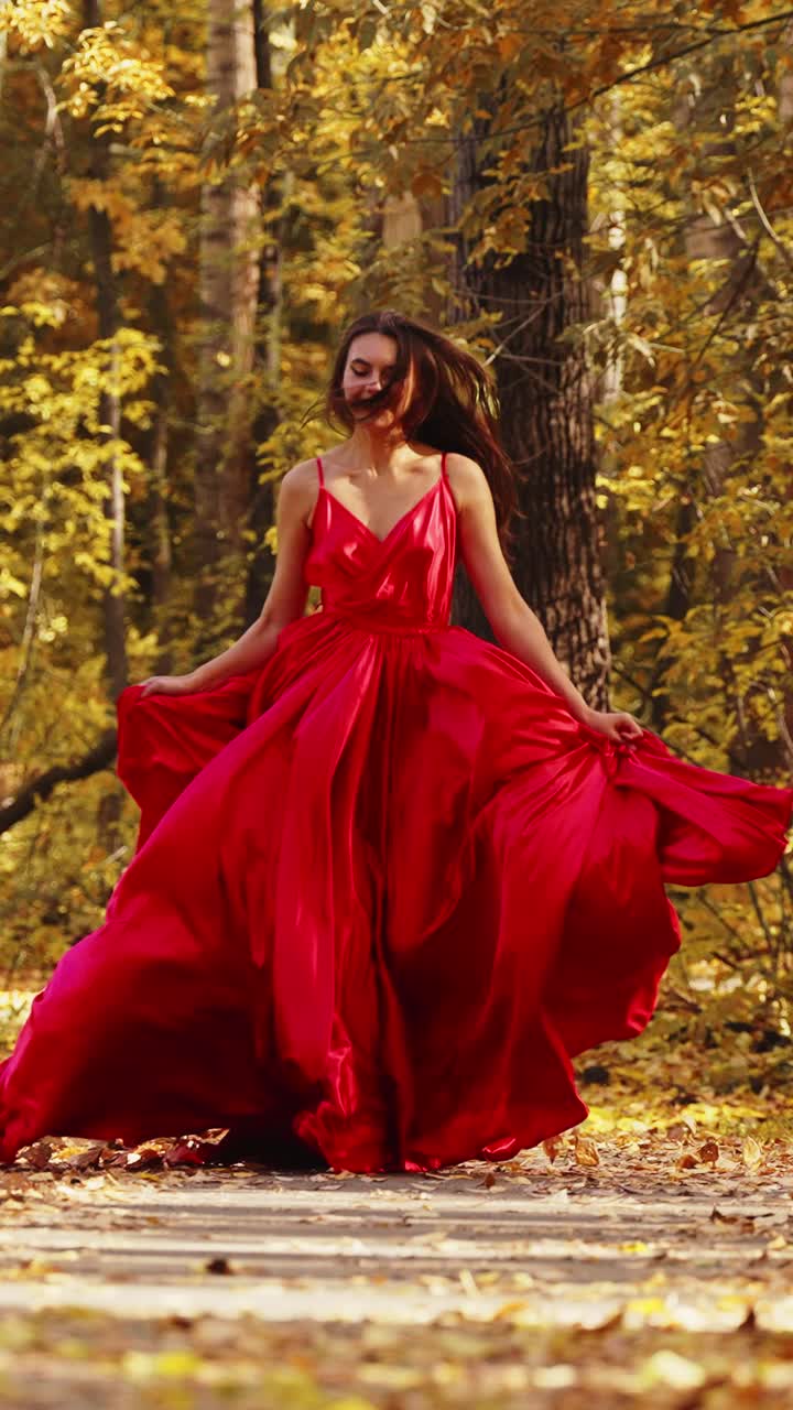 A captivating journey through a vibrant autumn forest, featuring a graceful figure in a flowing red gown, showcasing elegance amidst nature's golden hues