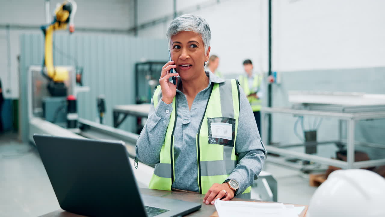 Factory Worker on Phone and Laptop