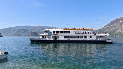 ferry nearing dock with scenic mountain backdrop