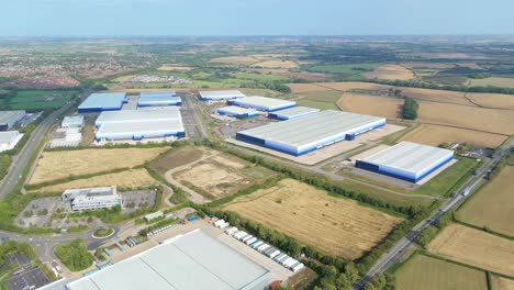 aerial panning drone shot of large industrial warehouses and business distribution centres at magna park lutterworth uk logistics hub in summer light