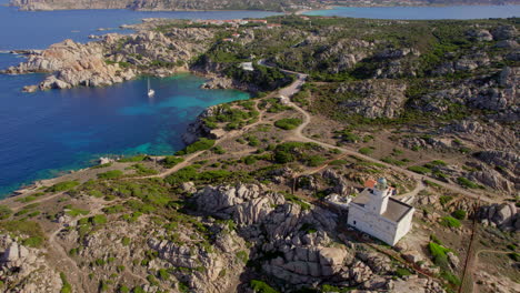 Aerial-view-in-a-circle-over-the-Cape-Testa-lighthouse-and-the-beautiful-coast