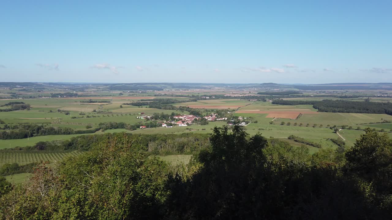 Panoramic view of Sion Hill in Vaudémont, showcasing lush fields, forests, and distant villages under a clear sky.