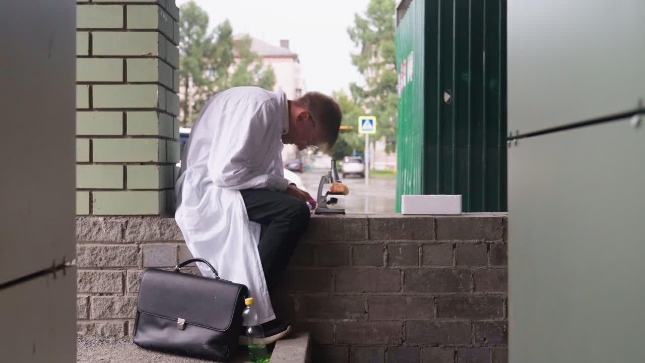 Scientific researcher in white coat sits outdoors carefully examining pastry first with magnifying glass then with microscope, reflecting focus, curiosity, scientific observation