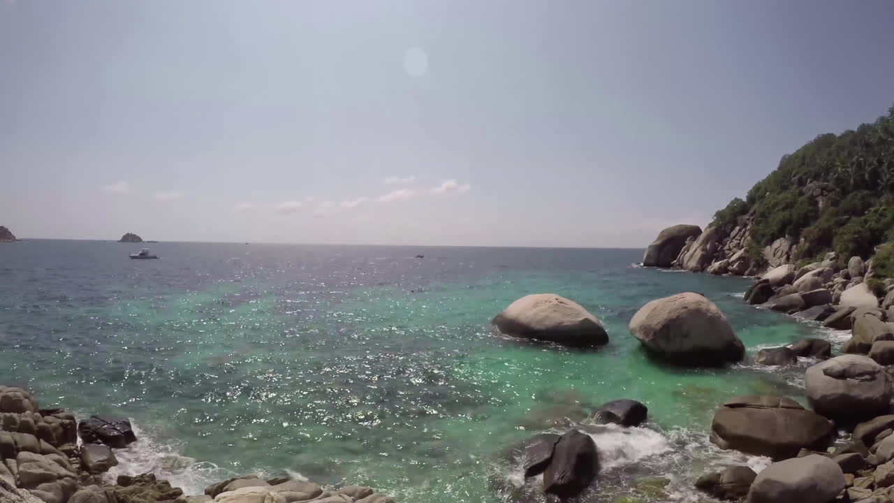 Rocks of the coastline and the sea. Panoramic time lapse at bright sunny day