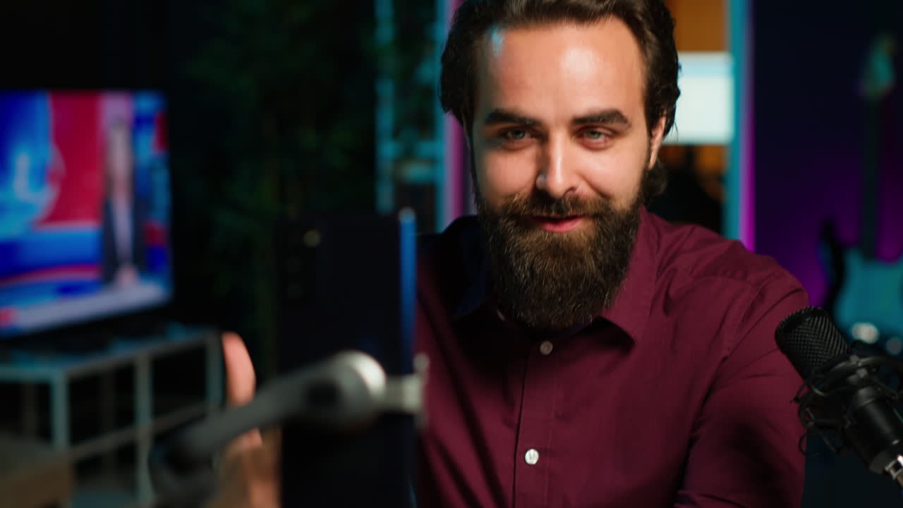 Man filming q and a session with mobile phone, answering questions