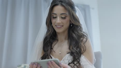 bride reacting to surprise video message from groom on their wedding day
