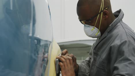 male car mechanic wearing face mask working