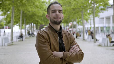 handsome bearded man posing with crossed arms.