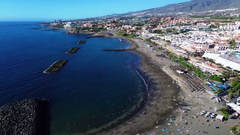 volcanic sand beach in south tenerife, costa adeje spain