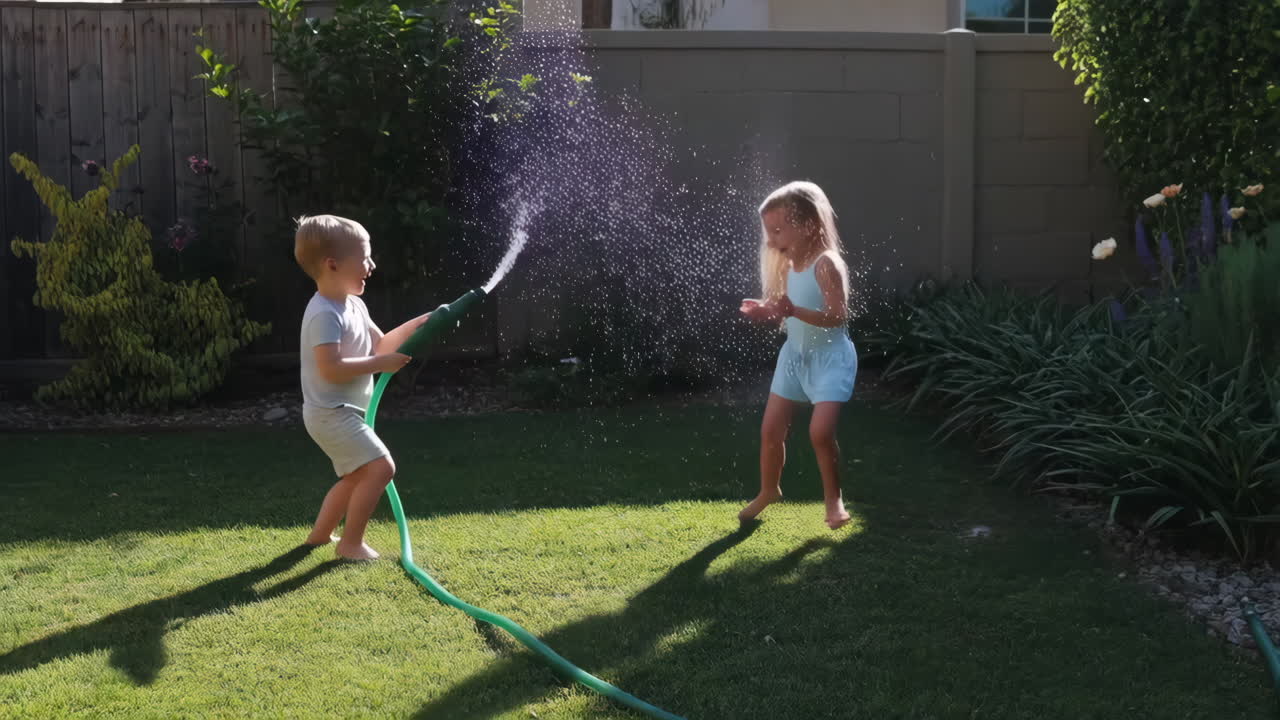 Kids playing with a water hose in the backyard on a sunny day
