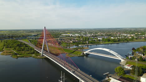 aerial view of third millennium john paul ii bridge next to railway bridge spans on martwa wisla river in gdansk, poland