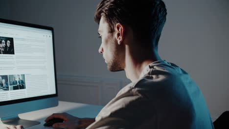 man working on computer at night