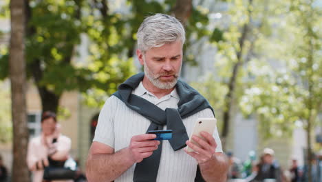 shocked man trying to pay online shopping with smartphone blocked credit card lack of money balance