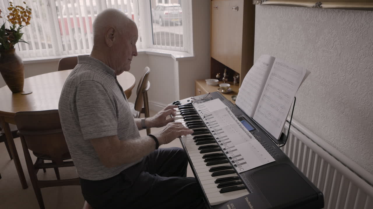 Elderly man playing piano at home